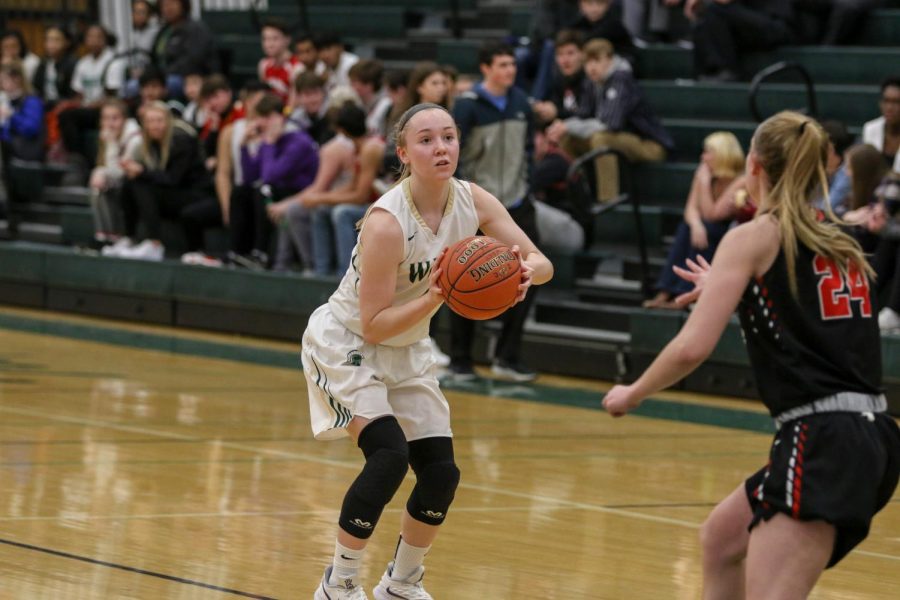 Cora Saunders '20 squares up for a three against Linn-Mar on Dec. 20.