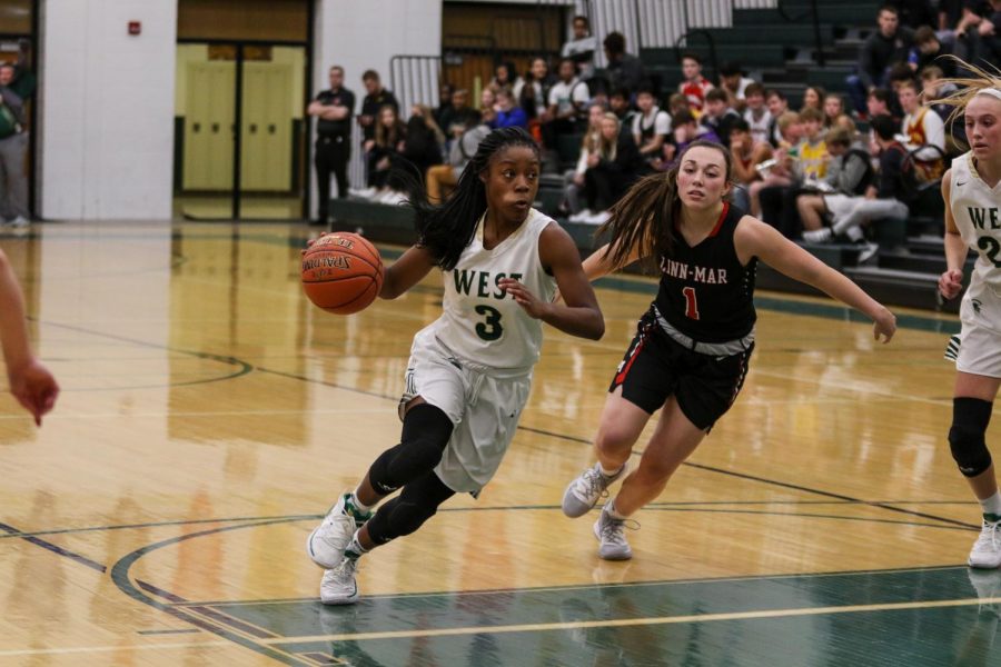 Matayia Tellis '21 drives into the lane against Linn-Mar on Dec. 20.