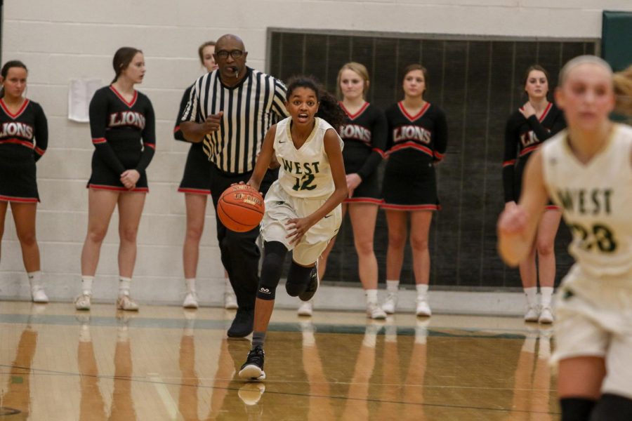 Meena Tate brings the ball up the court against Linn-Mar on Dec. 20.