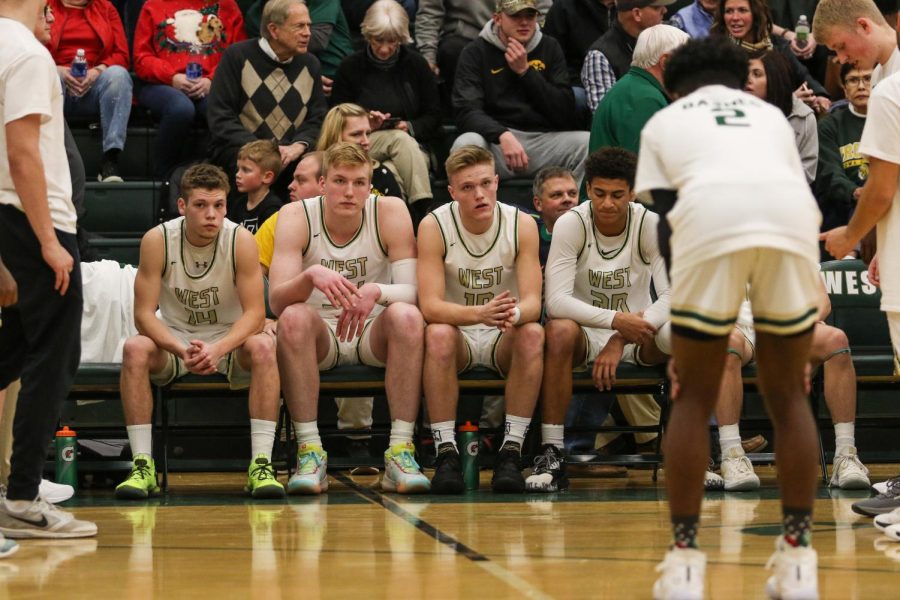 Starters wait to be called against Linn-Mar on Dec. 20.