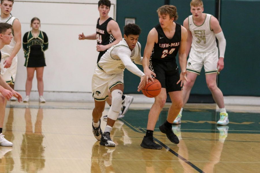 Marcus Morgan '21 steals the ball against Linn-Mar on Dec. 20.