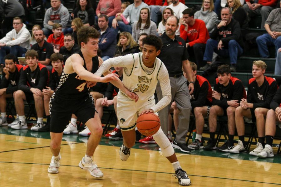 Marcus Morgan '21 drives baseline against Linn-Mar on Dec. 20.