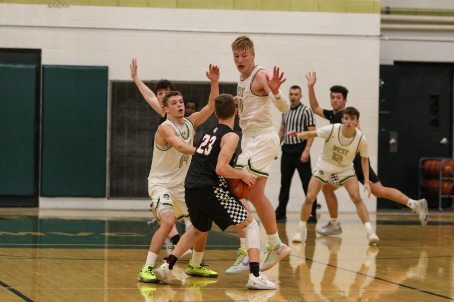 Nick Pepin '20 and Even Brauns '20 trap Linn-Mar's John Steffen '20 on Dec. 20.