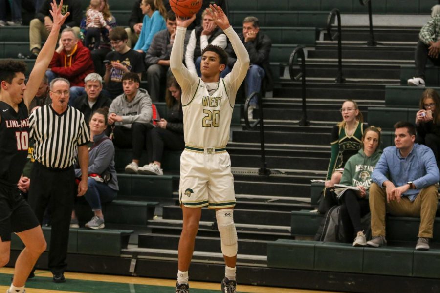 Marcus Morgan '21 knocks down a shot against Linn-Mar on Dec. 20.