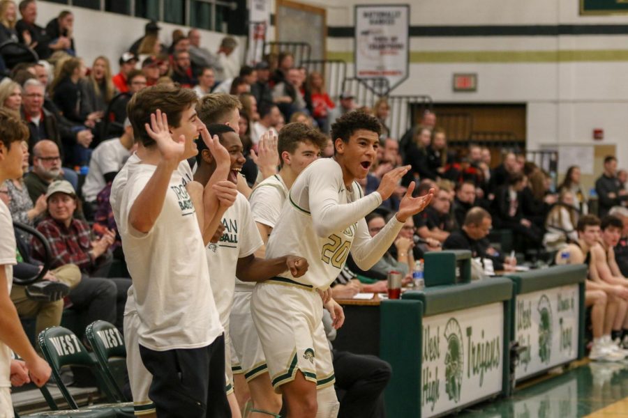 Marcus Morgan '21 and his teammates celebrate an and one against Linn-Mar on Dec. 20.