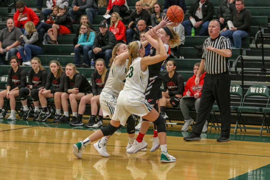 Cora Saunders '20 and Audrey Koch '21 trap the Western Dubuque point guard.