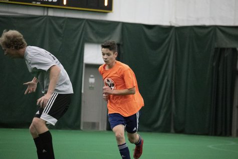 Nicolo Schianchi '22 comes up behind coach Chris Clegg during his first game of the night during Men's League on Dec. 6 2019.