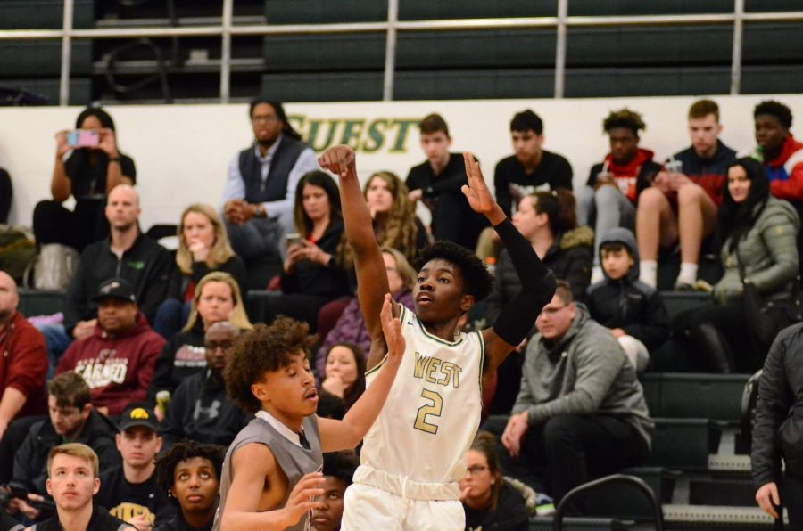 Christian Brauns '22 shoots a three-pointer in the first quarter of the game on Jan. 21.