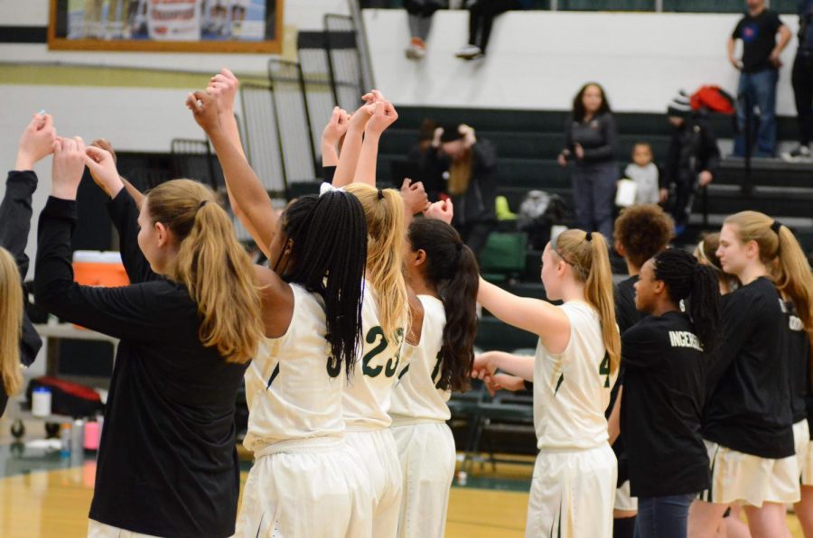 In the last seconds of the Pledge of Allegiance the Women of Troy grab pinkies and throw their arms in the air to show respect on Jan. 15.