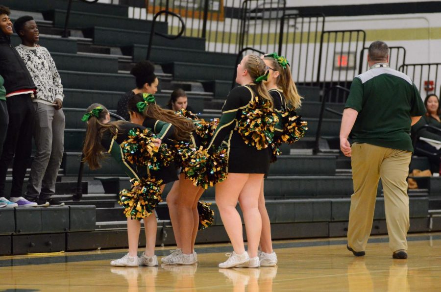 The West High cheerleaders lead the student section to bring hype to the game against Waterloo East.