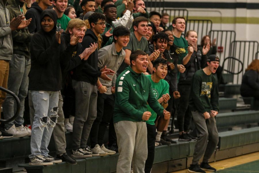 Makhi Halvorsen '20 and the student section celebrates an Even Brauns' '20 dunk against Dubuque Hempstead on Jan. 7.