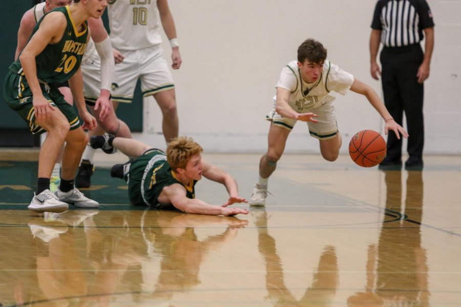 Joe Goodman '20 reaches for a loose ball against Dubuque Hempstead on Jan. 7.