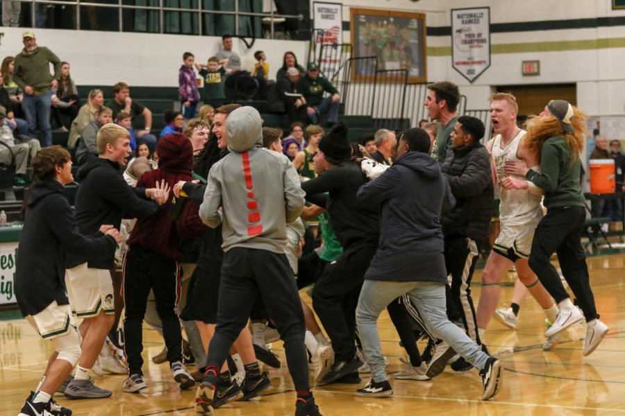 Students and players storm the court after beating Dubuque Hempstead on Jan. 7.