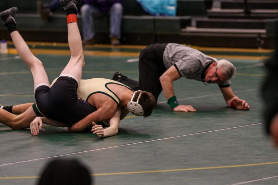 Parker McBride 22 pins his Liberty opponent at 120 pounds on Jan. 16.