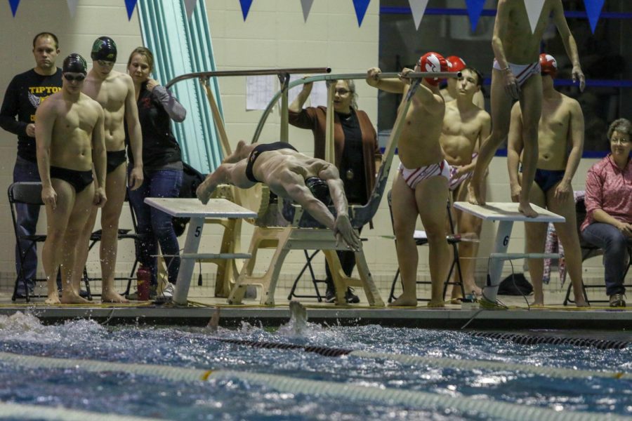 Diggory Dillingham '23 flys off the blocks during the 200-yard medley relay against City on Jan. 21.