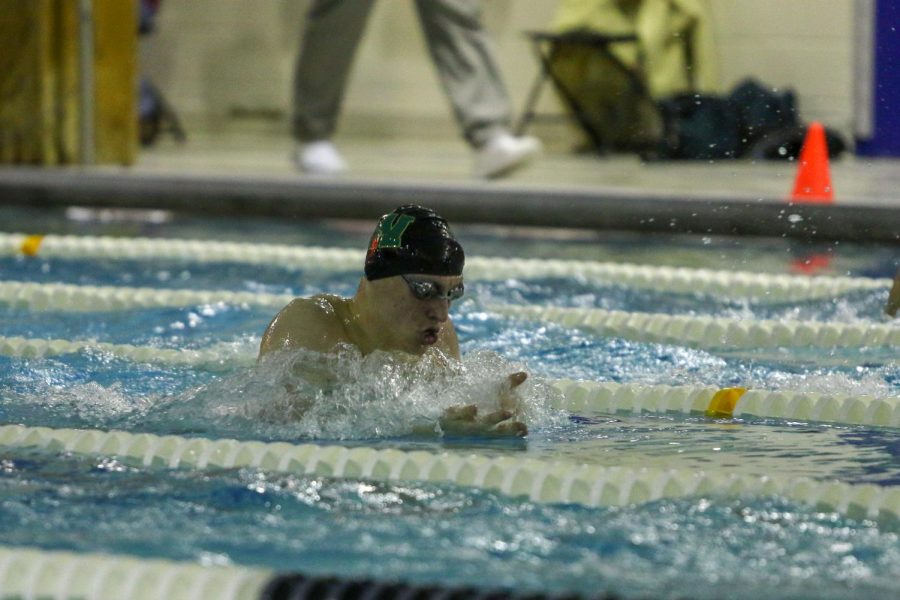 Jordan Christensen '22 swims in the 100-yard breaststroke against City on Jan. 21.