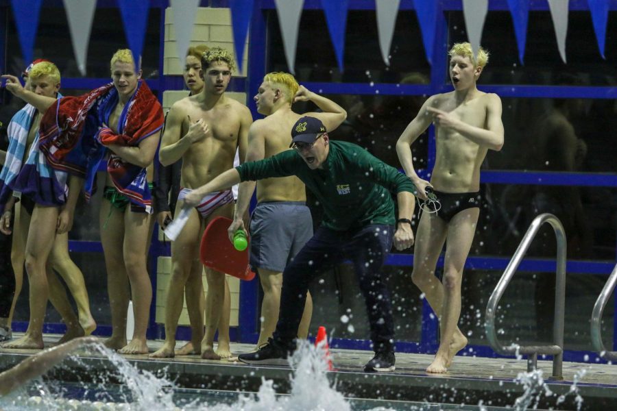 Head coach Byron Butler coaches from the edges of the pool against City on Jan. 21.