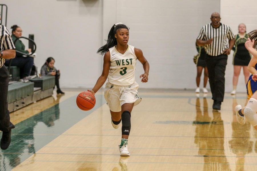 Matayia Tellis '21 pushes the ball up the floor during the first quarter against Dubuque Wahlert on Jan. 28.