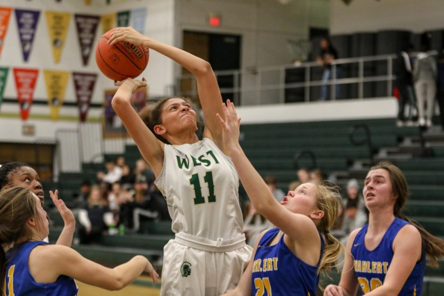 Liv Williams hauls in a rebound against Dubuque Wahlert on Jan. 28.