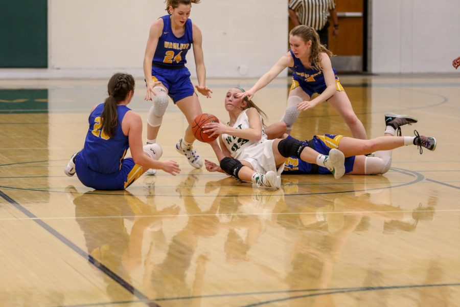 Audrey Koch '21 looks to pass after diving for a loose ball against Dubuque Wahlert on Jan. 28.