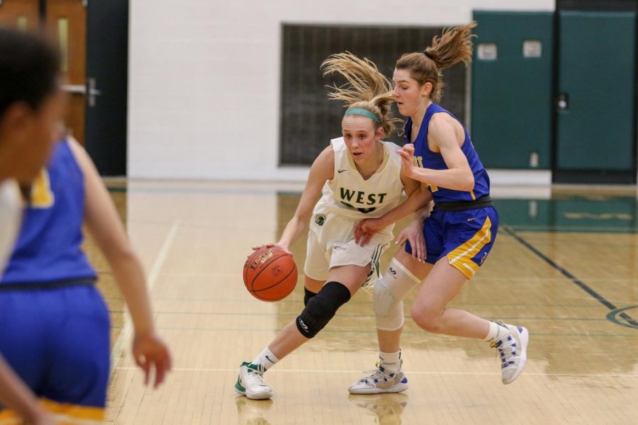 Audrey Koch '21 drives past the half court trap against Dubuque Wahlert on Jan. 28.