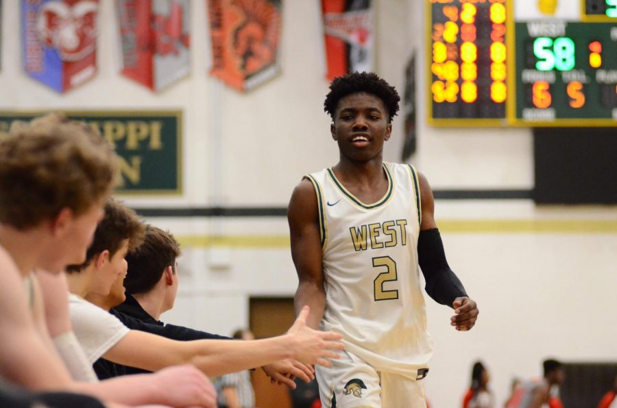 Christian Barnes '22 is congratulated by his team Jan. 31.