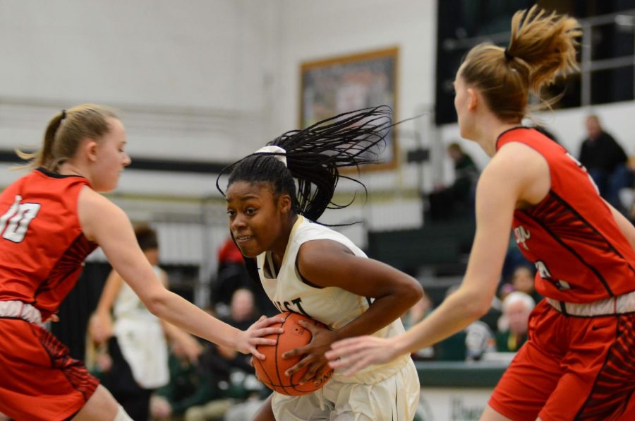 Mataiya Tellis '21 holds tight to the ball as two defenders double team her on Jan. 31. 