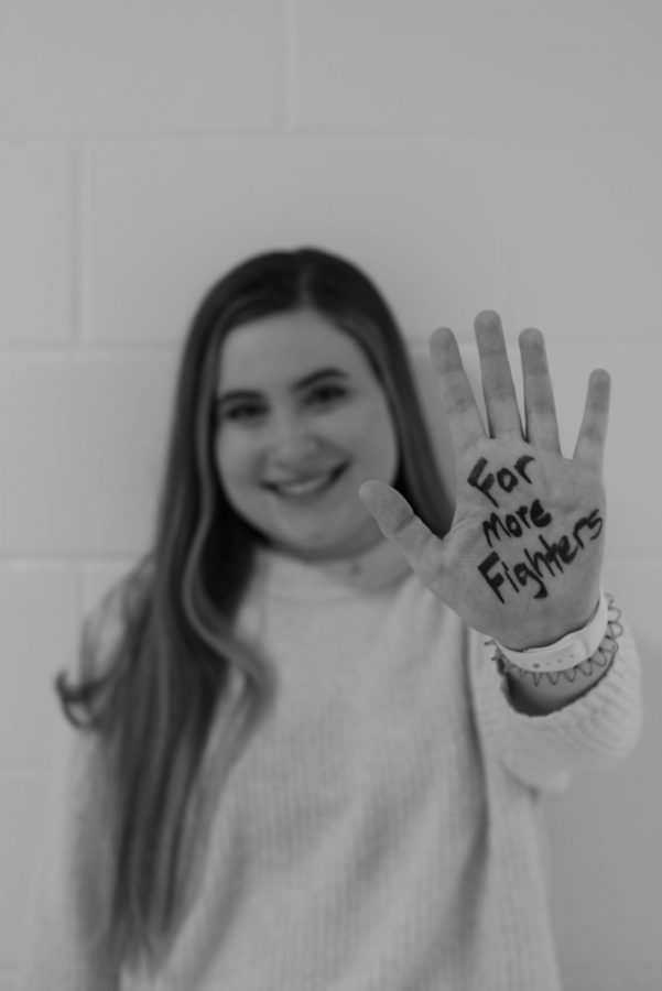 Katherine Yacopucci '20 shows off the reason she is involved with West High Dance Marathon: for more fighters.