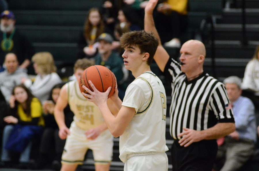 Senior Joe Goodman surveys the court for an open teammate to pass the ball into the court Jan. 31.