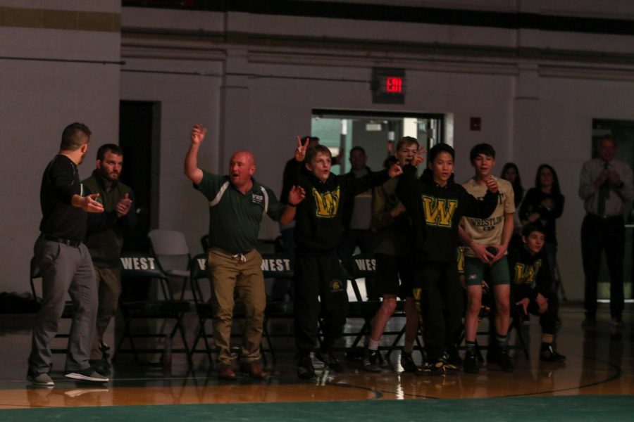 Grant O'Dell '22 and the rest of the team celebrate a takedown from Will Hoeft '20.