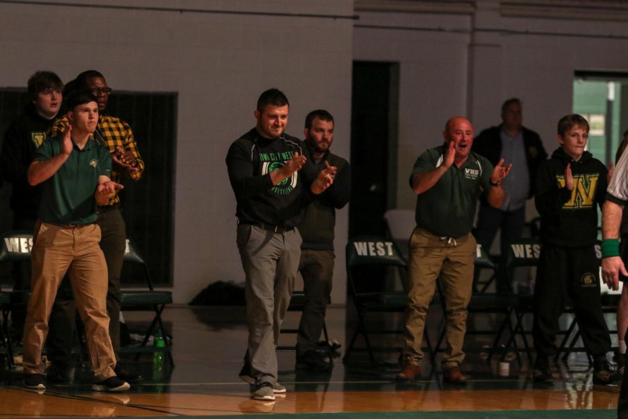 The coaches encourage Brett Pelfrey '22 during his match at 195 pounds.