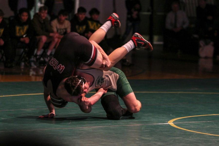 Will Hoeft '20 flips his opponent during Senior Night Feb. 6. Hoeft pinned Waterloo West's Christian Chapman '22 in the second period.