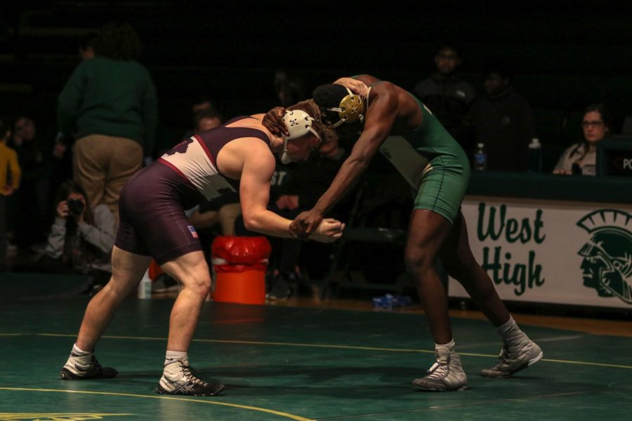 Anu Dokun '20 jockeys for position during his match on Senior Night Feb.6. Dokun overcame a 3-5 deficit to win by a 12-8 decision.