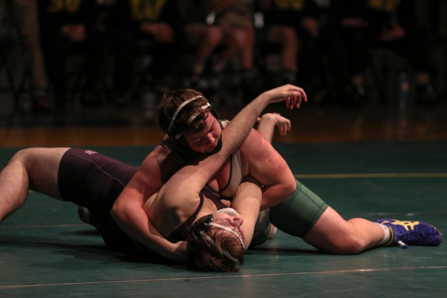 Brett Pelfrey '22 attempts to pin his opponent on Feb. 6.