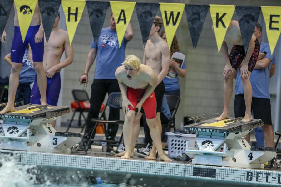 Jordan Christensen '22 cheers on his teammates from the edge of the pool during the 200 Yard Medley Relay on Feb. 15.