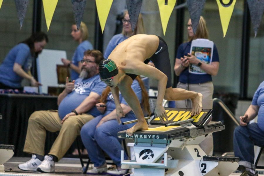 Nikolas Sung '22 gets set on the blocks as he waits to swim the 500 yard freestyle on Feb. 15.