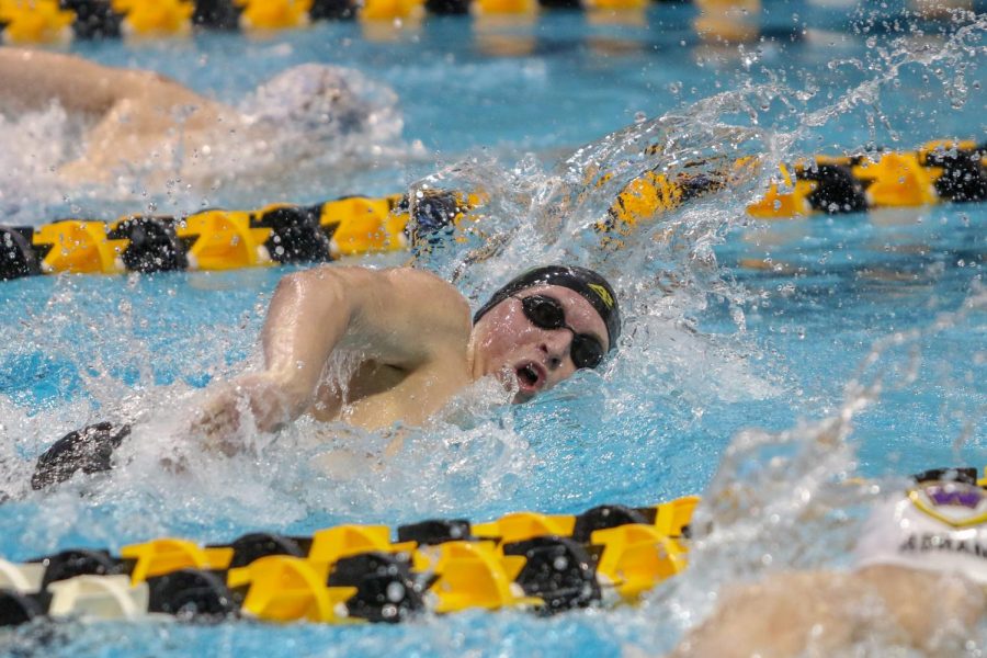 James Pinter '20 takes a breath as he swims in the 200 yard medley relay on Feb. 15.