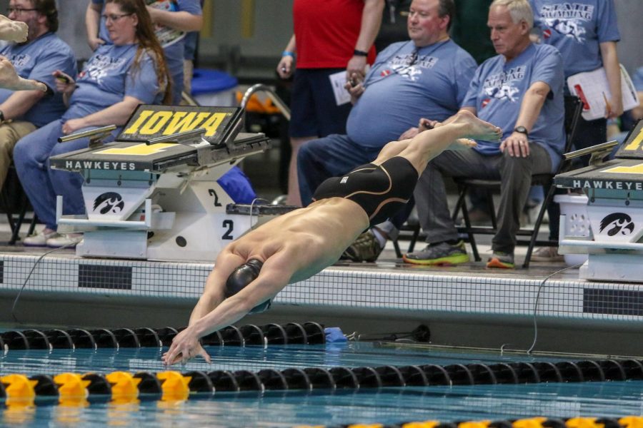 Izaak Hajek '20 dives in at the start of the 100 yard butterfly on Feb. 15.