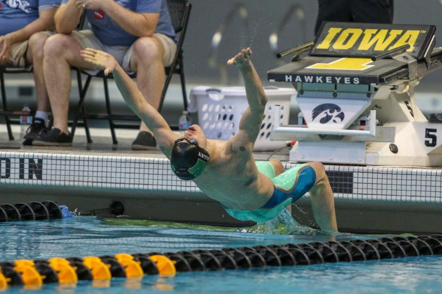 Boyd Skelley '22 reaches out at the start of the 100 yard backstroke on Feb. 15.