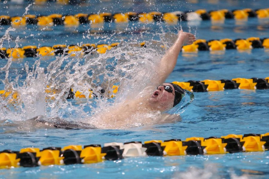 James Pinter '20 takes a breath during the 100 yard backstroke on Feb. 15. Pinter won the 100 yard backstroke state championship with a time of 50.01.