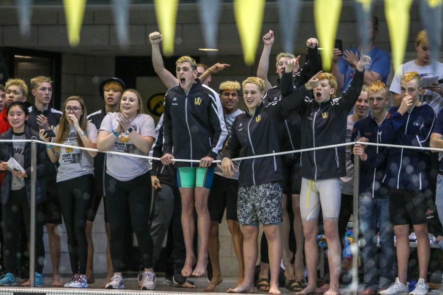 Boyd Skelley '22 and his teammates cheer on the 400 yard freestyle relay on Feb. 15 to seal the deal for the teams state championship.