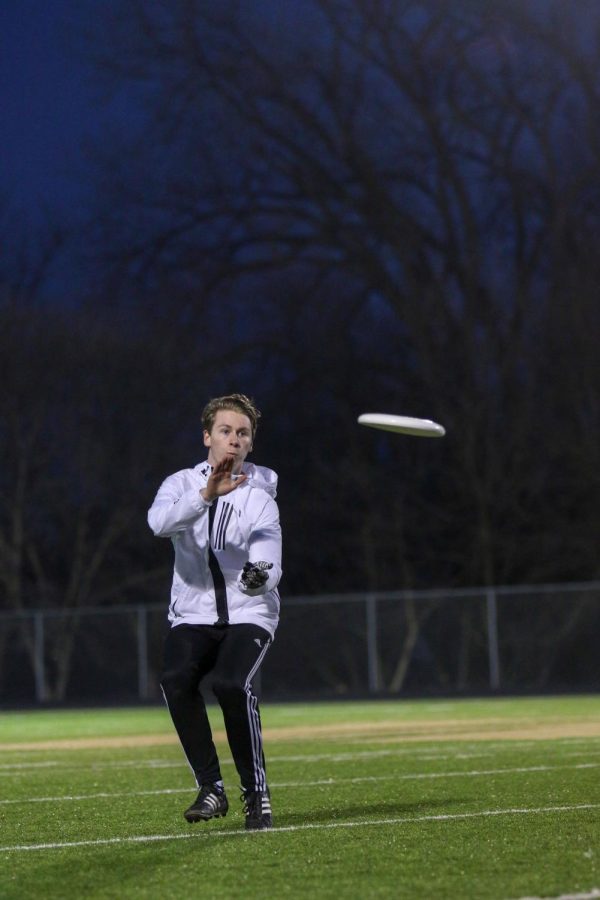 Sean Harken '21 focuses in on the disc before securing the frisbee during the team's scrimmage on March 6.