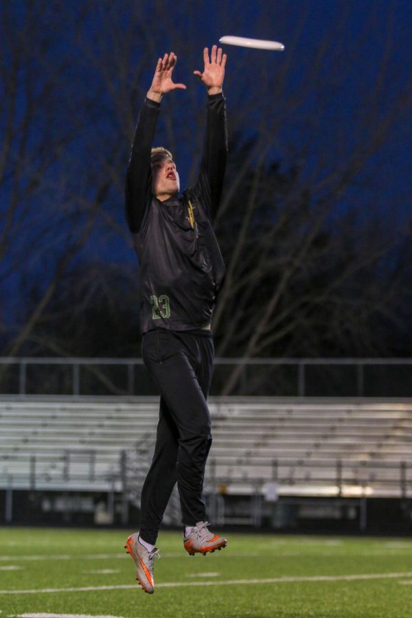 While fully extended, Danny Bodin '20 snatches the frisbee out of the air.