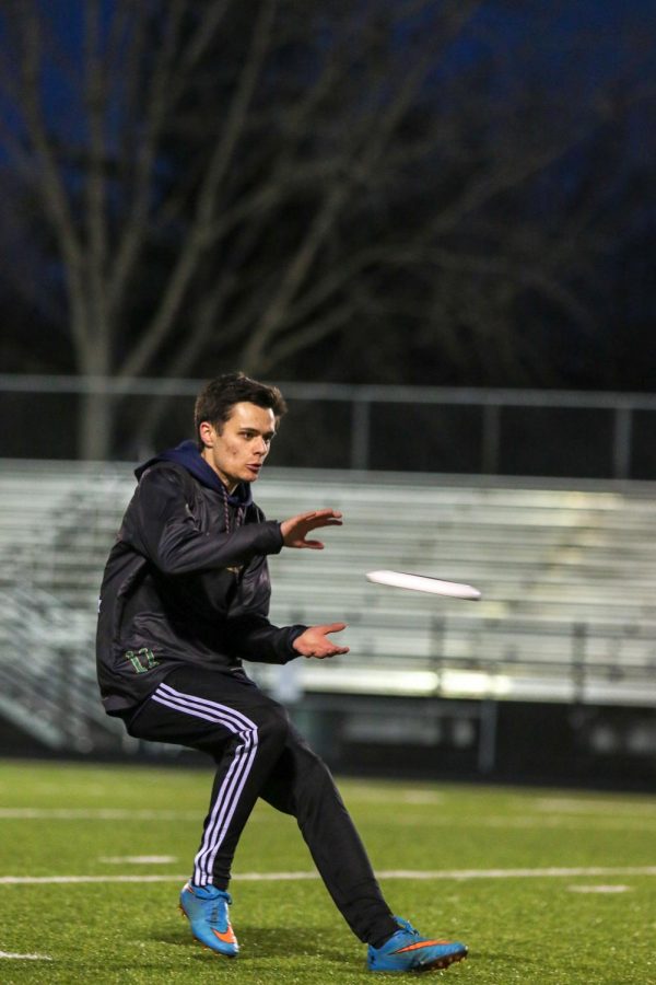 Davis Larson '20 breaks down to catch the frisbee during the team's scrimmage on March 6.