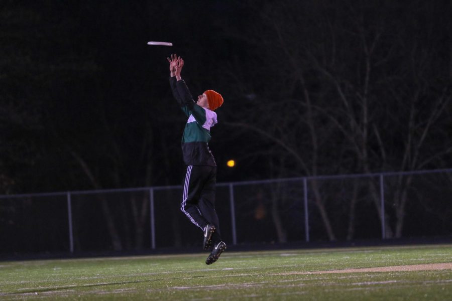 Ed Dowling '20 jumps in the air to grab the frisbee during the team's scrimmage.