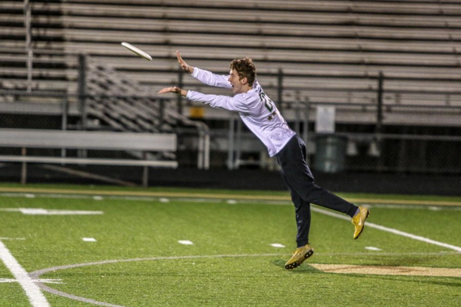 Quinn Eberly '20 leaps through the air to secure the frisbee for his team during the scrimmage.