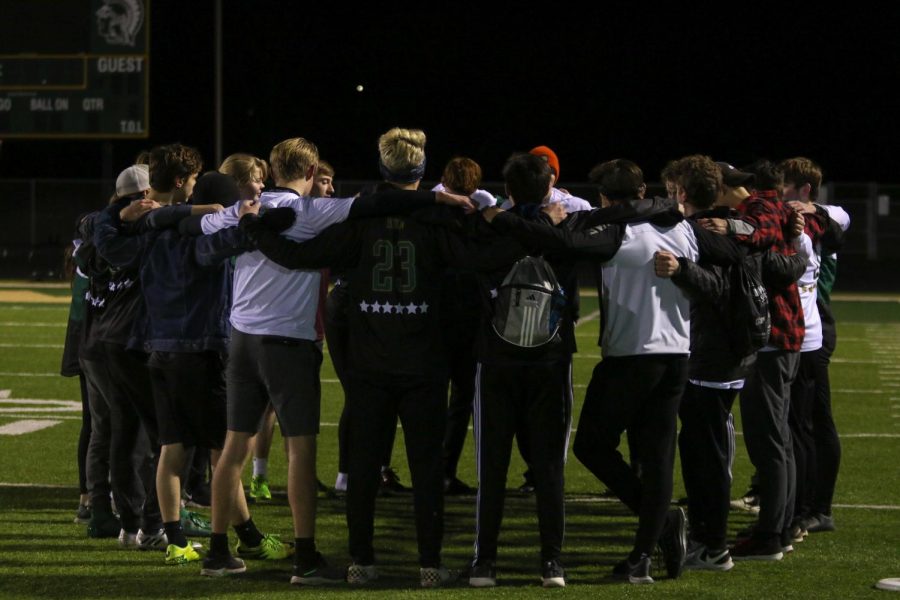 The Wings huddle up after practice on March 6.