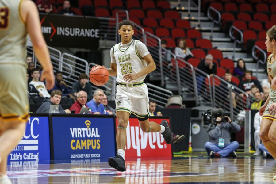 Marcus Morgan '21 pushes the ball up the floor during the state quarterfinal on March 11.