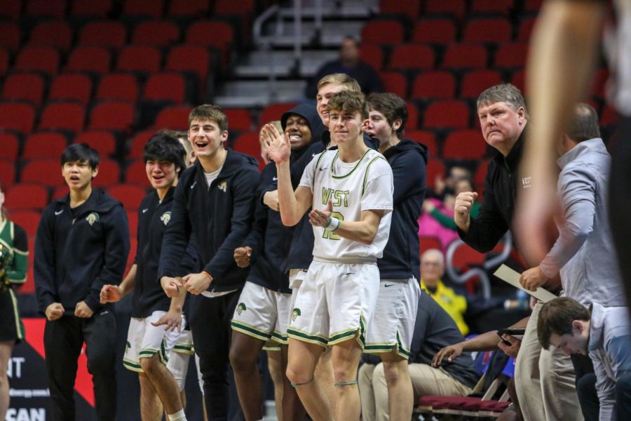 Joe Goodman '20 and the bench celebrates a bucket during the state quarterfinal on March 11.