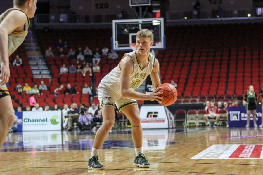 Tate Crane '20 looks to pass at the top of the key during the state quarterfinal on March 11.